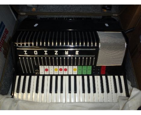 A CASED HOHNER ELECTRAVOX PIANO ACCORDION, (incomplete), and a Carloti Riviera accordion, both in original cases (2)