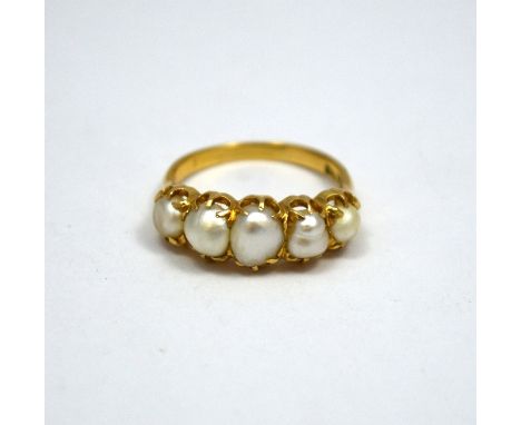 A LATE VICTORIAN PEARL RING, with five graduated possibly natural (untested) pearls, to the 18ct yellow gold shank, stamped 1