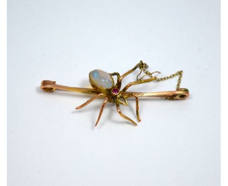 AN EARLY TWENTIETH CENTURY BROOCH, depicting a spider, with oval shape opal body and ruby head to the plain bar