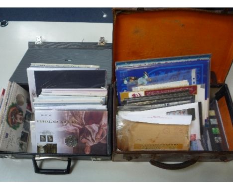 TWO SUITCASES CONTAINING PRESENTATION PACKS, and over 40 Royal Mail and other coin covers, to include two stamp Ingots .925, 