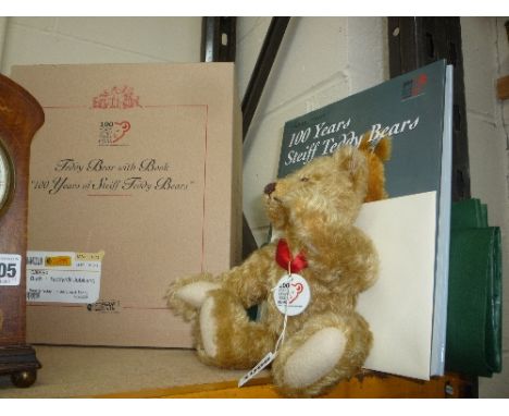 A BOXED STEIFF 100 YEARS TEDDY BEAR WITH BOOK, 23cm tall, with 100 Years Porcelain pendant and copy of book '100 Years of Ste