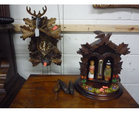 A MODERN BLACK FOREST CUCKOO CLOCK, pendulum and two weights etc (2)