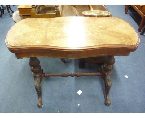 A VICTORIAN WALNUT FOLD OVER CARD TABLE, of serpentine form (s.d., losses)