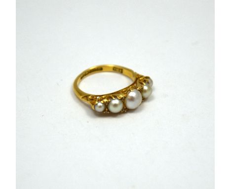 AN 18CT GOLD PEARL AND DIAMOND RING, with five graduated pearls with diamond accents, to the decorative ring shank, hallmarks