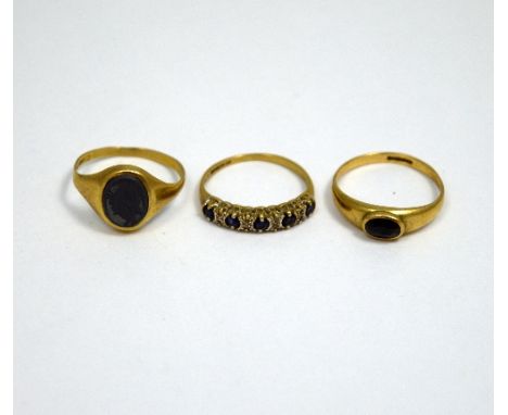 THREE 9CT GOLD RINGS, the first a hematite signet ring, together with a sapphire band ring and a further band ring, hallmarks