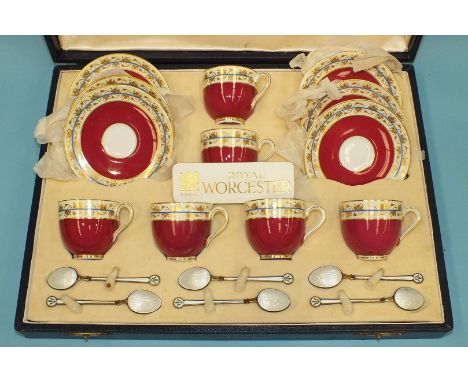 A Royal Worcester coffee set comprising six each coffee cups and saucers, pattern no. Z1754, decorated puce, blue, yellow and