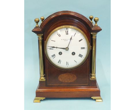 An early-20th century mahogany mantel clock of arched architectural form, the convex white dial signed "W Batty & Sons Ltd, M