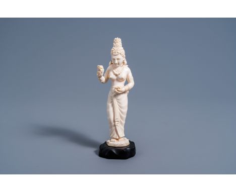 Full title: An Indian carved ivory figure of a goddess holding flowers in her hands, ca. 1900Description: H 24 - 22 cm (with 