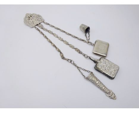 Early 20th century silver-plated Chantelaine, pierced scroll mount, three mask chains to a mask embossed scissor sheath, pin 