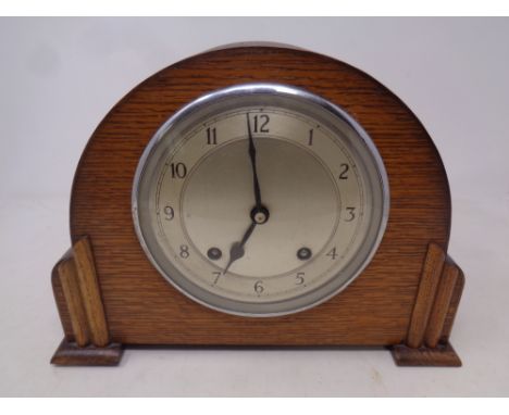 A 1930's oak cased Garrard mantel clock with key and pendulum 