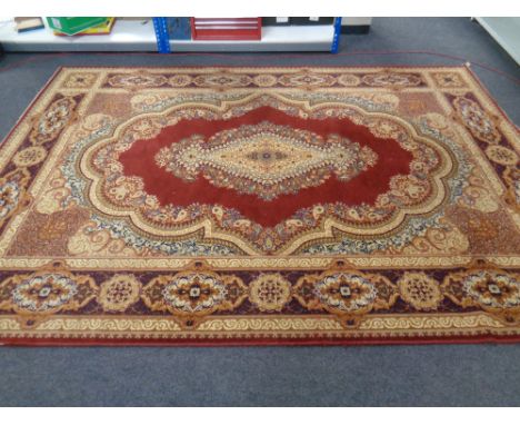  A machined Persian design carpet on gold and red ground with central medallion 