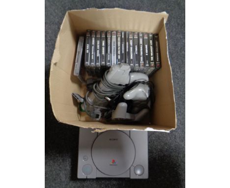 A Playstation one console with leads and accessories together with 15 assorted games