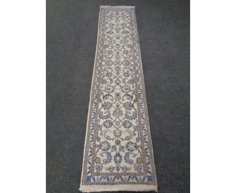 A floral carpet runner on cream ground 