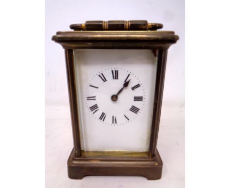 A brass cased carriage clock with key.