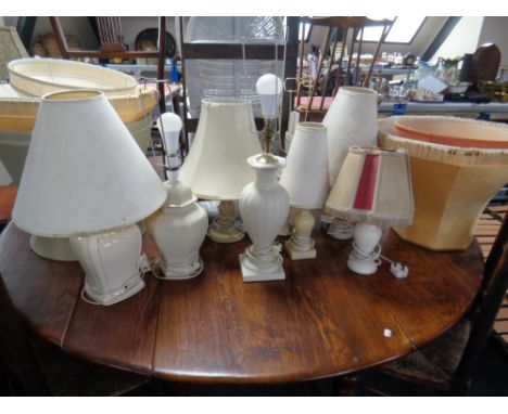 A quantity of assorted ceramic and marble table lamps together with a quantity of assorted shades.