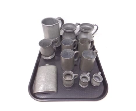 A tray of antique pewter, tankards and measuring jugs, English hammered pewter hip flask