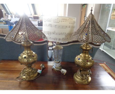 A pair of brass Moroccan style table lamps together with a further contemporary brass and cut glass table lamp with shade.