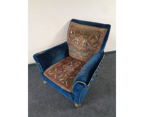 A Victorian armchair upholstered in blue dralon and Caucasian Afshar carpet 