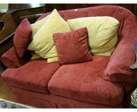 A Modern Sofa Covered in Red Fabric.