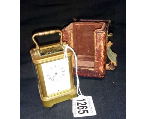 A Victorian carriage clock in leather travel case