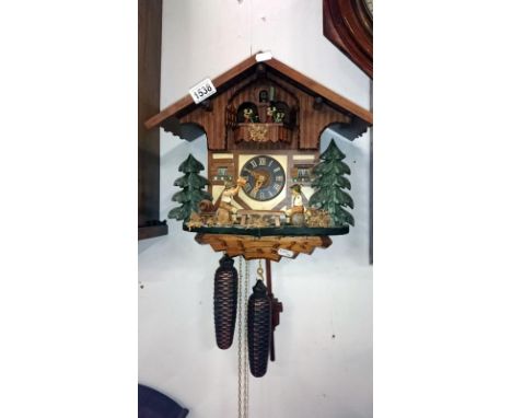 A cuckoo clock with 3 weights
