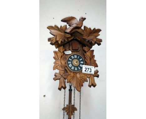A small cuckoo clock with weights