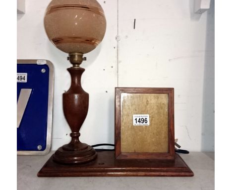 A 1930's oak table lamp with integral photo frame