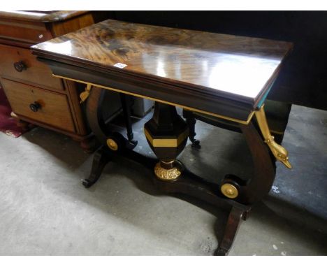 A Georgian mahogany card table with gilded swan necks to base, green felt playing surface and flame mahogany top