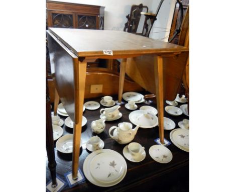 An Ercol light wood dropleaf table