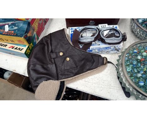 A boxed set of Halcyon mark goggles and a flying helmet type hat