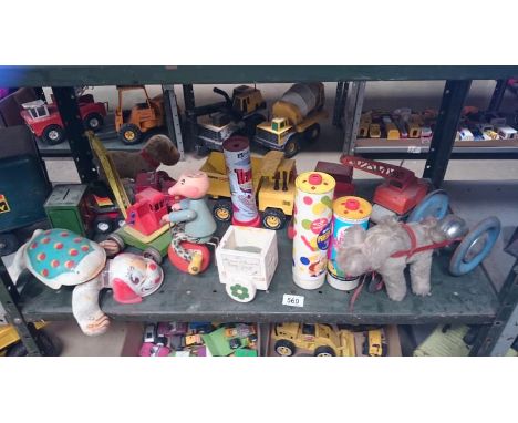 A shelf of wood and metal toys inc. Mobo, Matchbox etc.