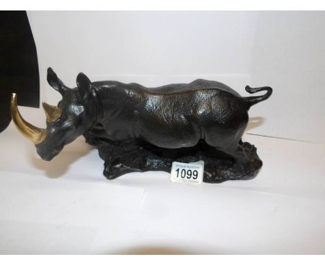 A bronze figure of a Rhino with gilded horns