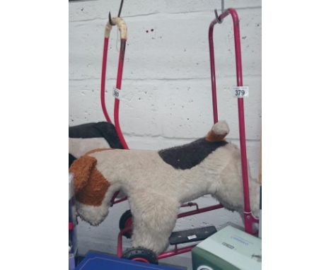 A childrens vintage push along dog