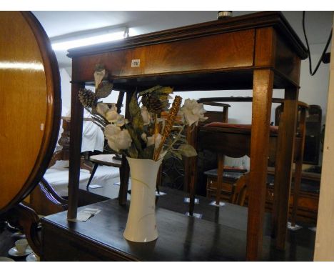 A mahogany fold over card table on tapered legs