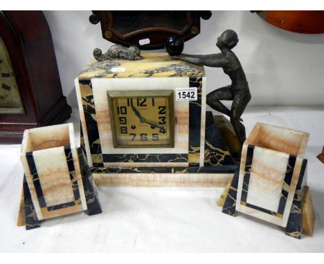A French art deco mantle clock set with mounted spelter figures and dog
