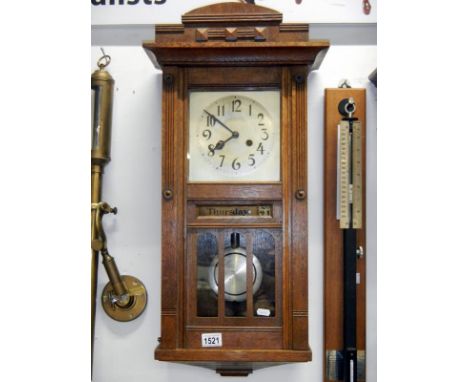 An art deco oak wall clock with day and date reel