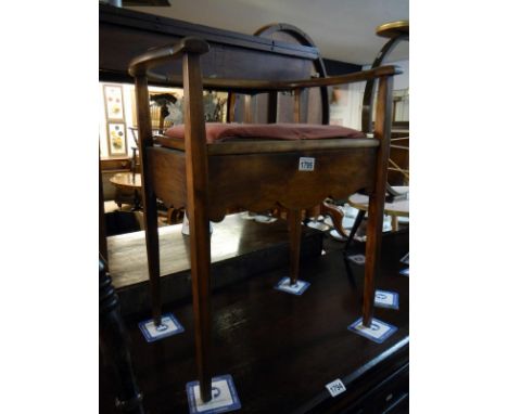 A piano stool with back rest