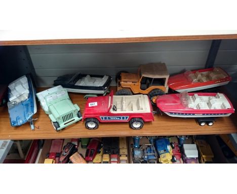 Shelf of Tonka Jeeps and trailers with speedboats