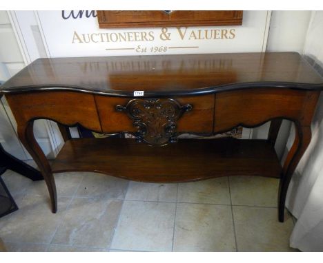 A serpentine dark stained sideboard with 1 draw and under shelf