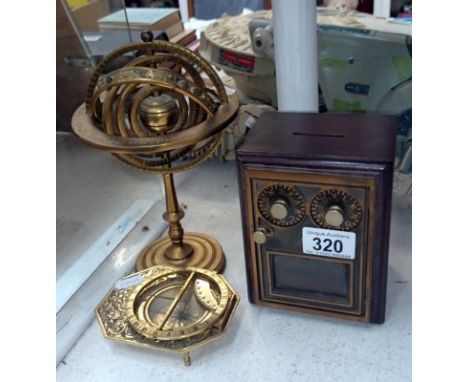 A brass astrological globe, brass compass and money box safe