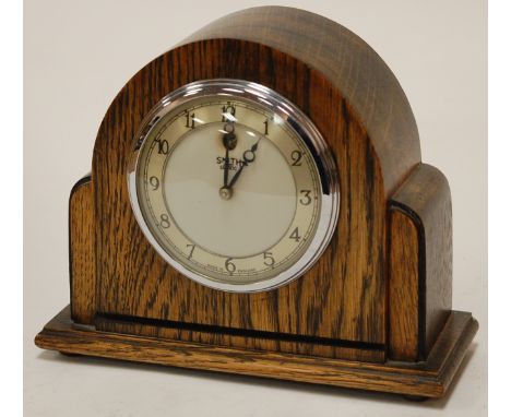 A small Art Deco oak cased mantel clock by Smith's, having a silvered dial with Arabic numerals 