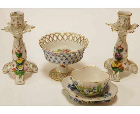 A pair of early 20th century Dresden porcelain floral encrusted dwarf candlesticks together with a similar teacup and saucer 