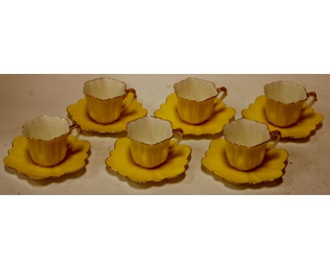 A set of six Foley china Wildman & Co. teacups and saucers each on yellow ground heightened in gilt, printed mark verso Condi