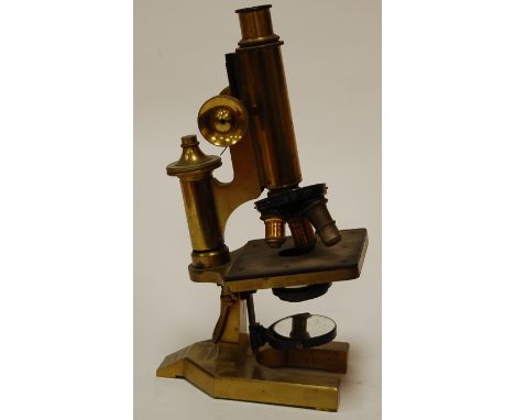 A circa 1900 lacquered brass monocular microscope by R & J Beck Ltd of London, No.25665; together with a various glass slides