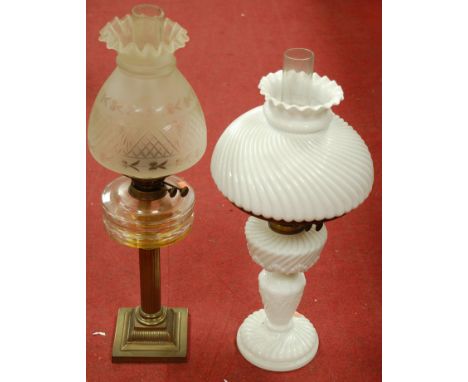 A circa 1900 pedestal oil lamp having an etched glass shade on brass column base together with one other opalescent glass exa