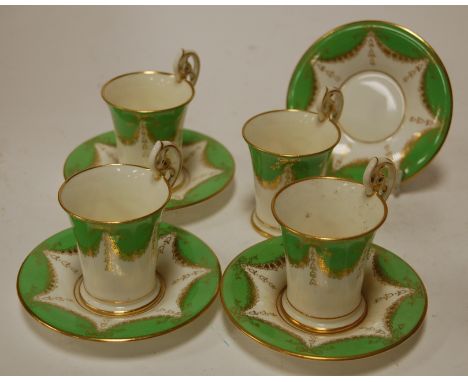 A twelve place setting of Coalport soft paste porcelain coffee cans and saucers, each heightened in gilt (lacking one can) Co