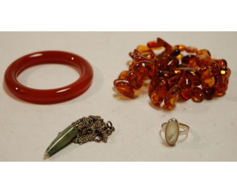 A collection of assorted costume and other jewellery to include child's coin bracelet, hardstone set brooch, jadeite bangle, 