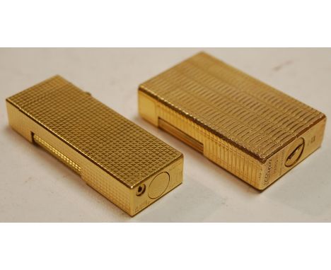 An S T Dupont of Paris gilt metal pocket cigarette lighter; and one other Dunhill example (2) 