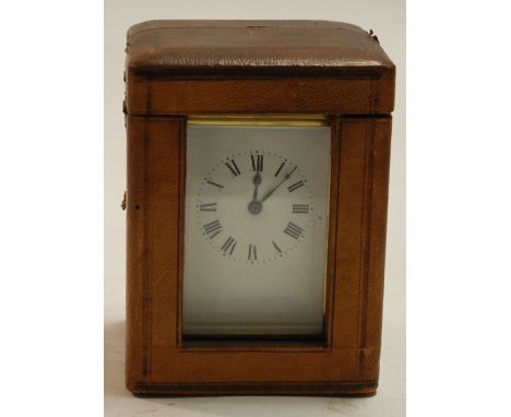 An early 20th century lacquered brass carriage clock having an enamel dial with Roman numerals and visible platform lever esc