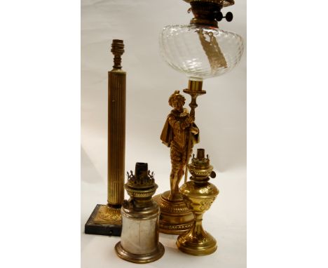 An early 20th century brass pedestal oil lamp, together with various table lamps, and a cast iron four division stickstand et